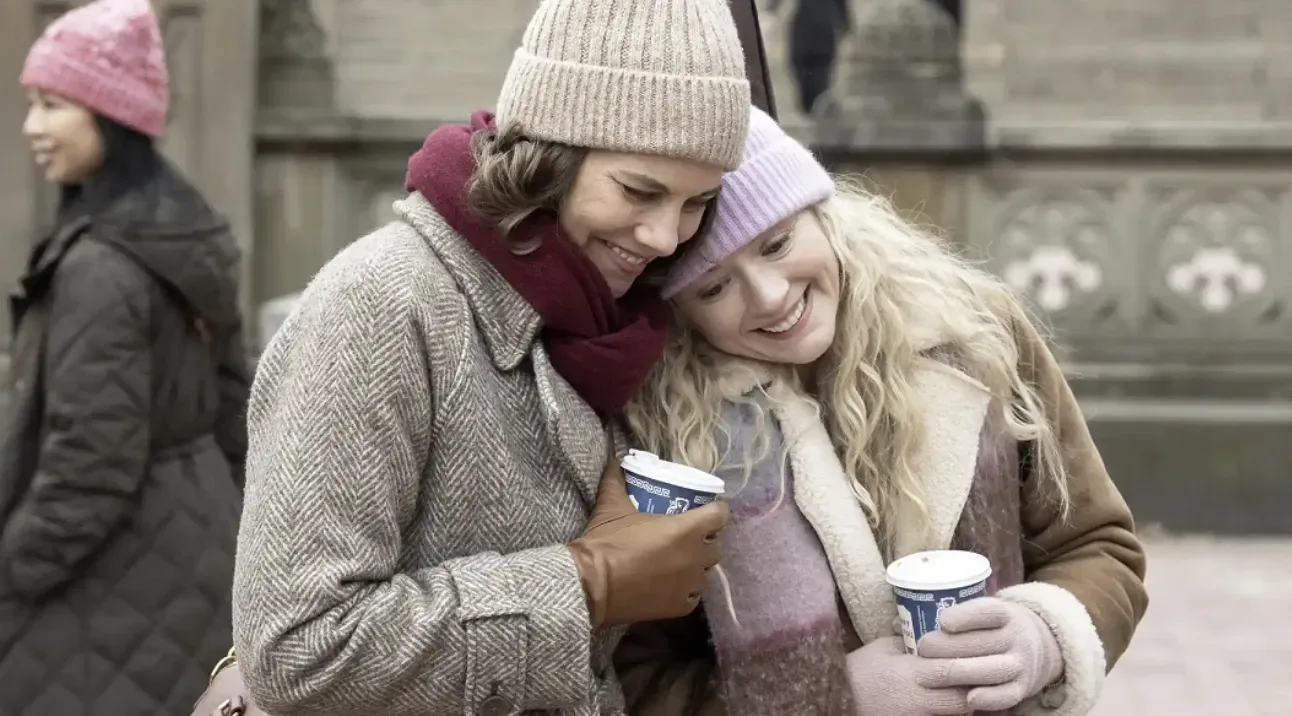 Two women embracing while holding coffee cups in The Walking Dead: Dead City.