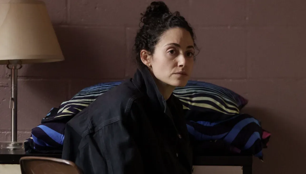 A woman seated indoors in a scene from Furious.