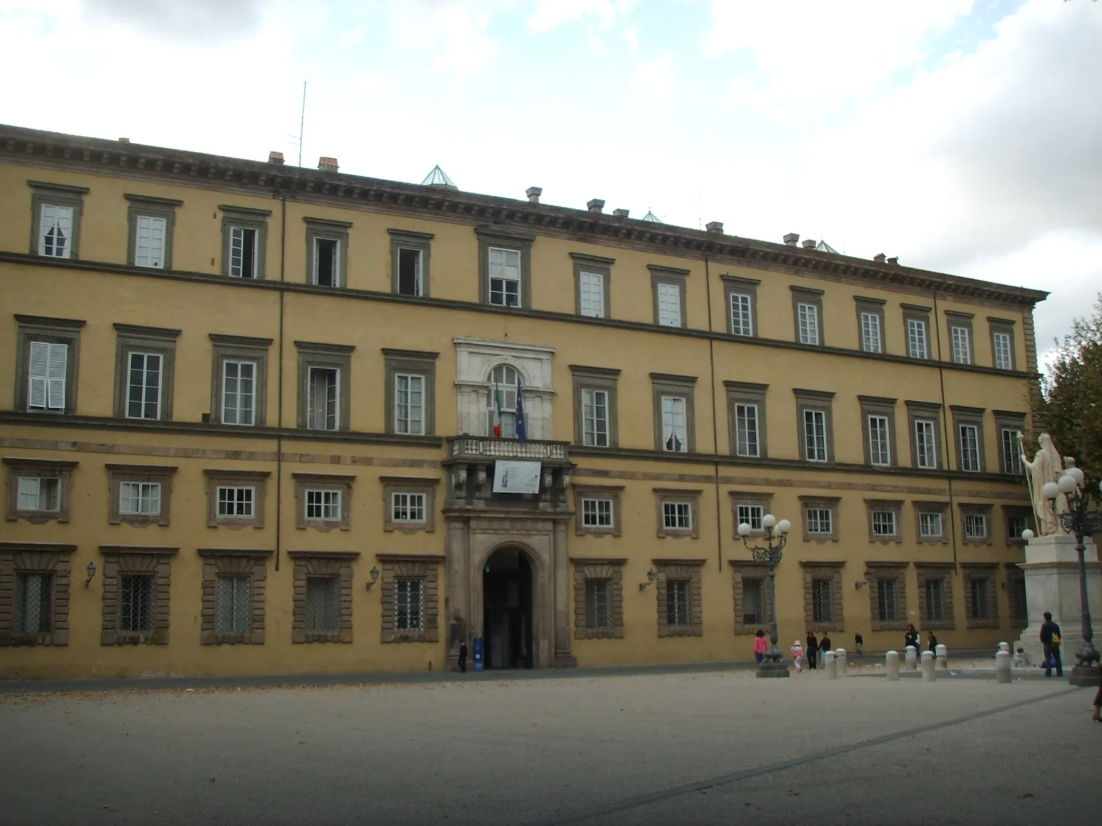 Ochre facade of Palazzo Ducale with rows of shuttered windows.